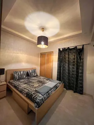 a bedroom with a bed and a ceiling at Opéra A Studio Apartment in Marrakech