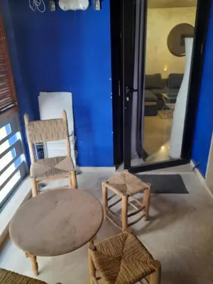a living room with two chairs and a table at Opéra A Studio Apartment in Marrakech