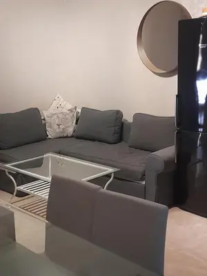 a living room with a couch and a table at Opéra A Studio Apartment in Marrakech