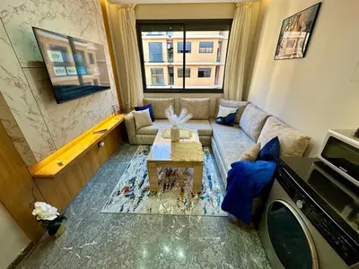 a living room with a couch and a table at Petit paradis près du centre in Marrakech