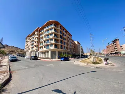 an apartment building on the corner of a street at Petit paradis près du centre in Marrakech