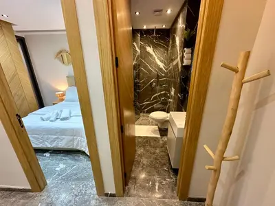 a bathroom with a bed and a toilet in a room at Petit paradis près du centre in Marrakech