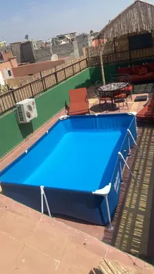 a blue pool table on a patio with a table at Appartement privatisé Gazelles MsHolidays Marrakech in Marrakech