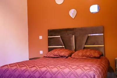 a bedroom with a bed with two pillows on it at Appartement privatisé Gazelles MsHolidays Marrakech in Marrakech