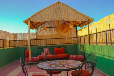 a patio with a table and chairs and a couch at Appartement privatisé Gazelles MsHolidays Marrakech in Marrakech