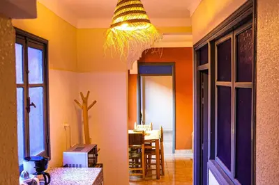 a room with a kitchen with a chandelier at Appartement privatisé Gazelles MsHolidays Marrakech in Marrakech