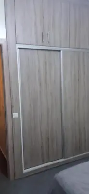 a pair of wooden cabinets in a room at appartement meublé accoté de l aéroport Marrakech in Marrakech