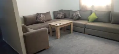 a living room with a couch and a table at appartement meublé accoté de l aéroport Marrakech in Marrakech