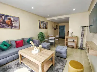 a living room with a couch and a table at Chic & Comfort Apartment in Marrakech