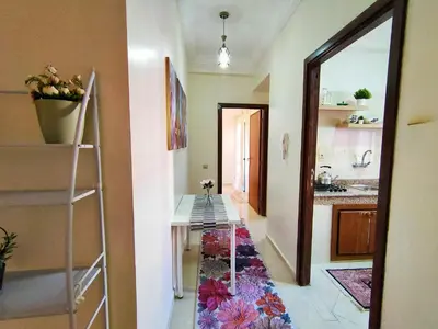 a room with a hallway with a table and a mirror at Stylish & Bright Apartment in Marrakech