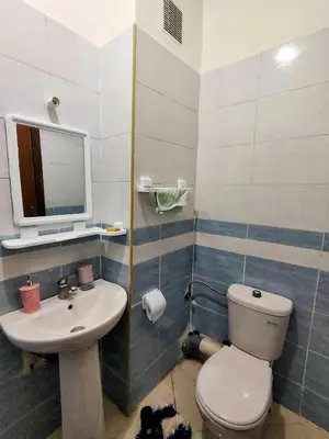 a bathroom with a toilet and a sink at Stylish & Bright Apartment in Marrakech