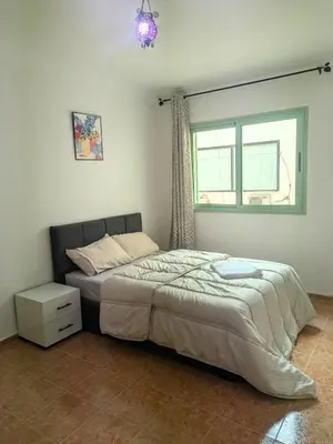 a bedroom with a large bed with a window at Cozy studio in a good location in Marrakech