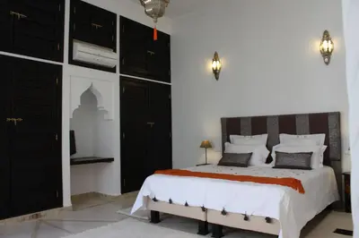 a bedroom with a large bed with black cabinets at Riad La Villa Marrakech in Marrakech
