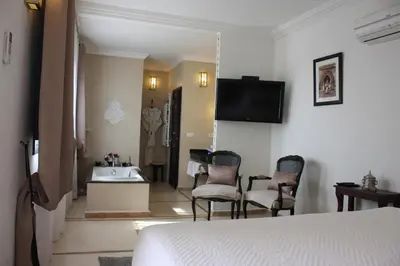 a hotel room with a bed and a sink at Riad La Villa Marrakech in Marrakech