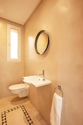 a bathroom with a sink and a toilet and a mirror at Luxurious Apartment in Marrakech in Dar Caïd Layadi