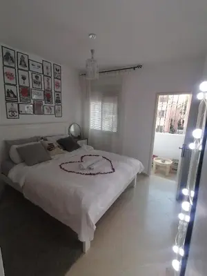 a bedroom with a large white bed in it at Appartement cosy in Marrakech