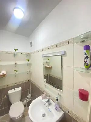 a bathroom with a toilet and a sink and a mirror at Appartement cosy in Marrakech