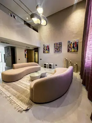 a living room with two large couches and tables at Majestic Duplex - Luxe et Confort au Cœur de Marrakech in Marrakech