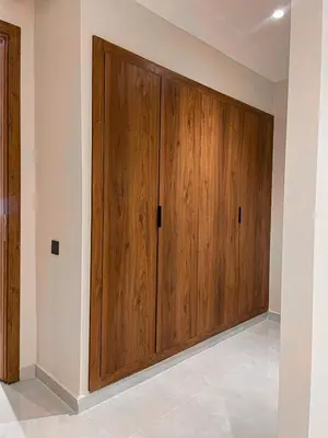 a pair of wooden doors in a room at Majestic Duplex - Luxe et Confort au Cœur de Marrakech in Marrakech
