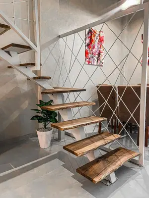 a staircase in a room with wooden benches at Majestic Duplex - Luxe et Confort au Cœur de Marrakech in Marrakech