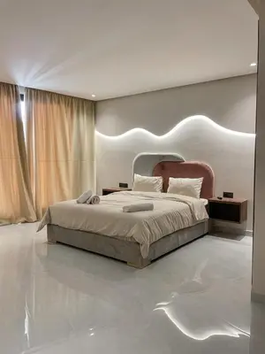 a bedroom with a large bed with a headboard at Majestic Duplex - Luxe et Confort au Cœur de Marrakech in Marrakech