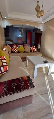 a living room with a couch and a table at Appartement familial résidence Hamza 2 chambres in Marrakech