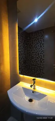 a bathroom with a sink and a mirror at luxurious and stylish apartment in Marrakech