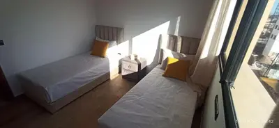 a small bedroom with two beds and a window at luxurious and stylish apartment in Marrakech