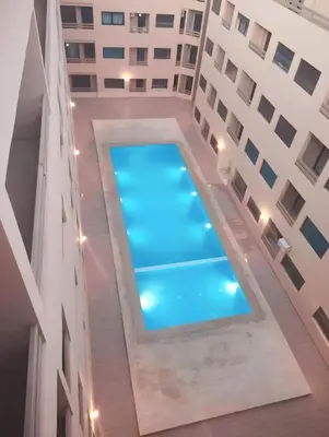 an overhead view of a swimming pool between two buildings at luxurious and stylish apartment in Marrakech