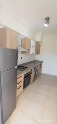a kitchen with a stainless steel refrigerator and a stove at luxurious and stylish apartment in Marrakech