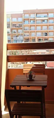 a wooden bench sitting in front of a window at luxurious and stylish apartment in Marrakech