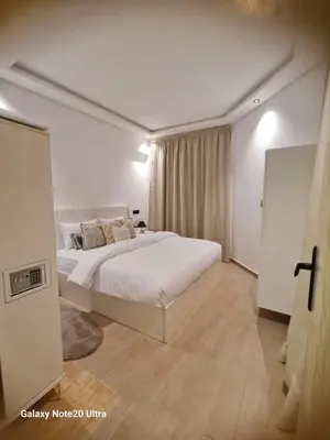 a bedroom with a large white bed in a room at Quiet studio in Marrakech