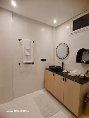 a bathroom with a shower and a sink and a mirror at Quiet studio in Marrakech