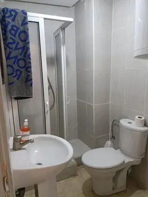 a bathroom with a toilet and a sink and a shower at family apartment 34 in Marrakech