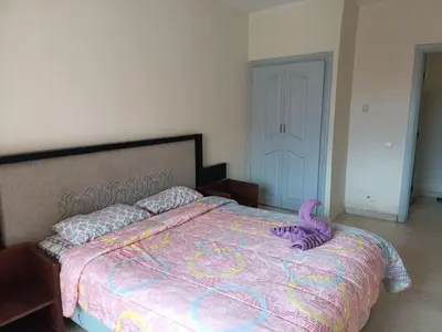 a bedroom with a large bed with a purple comforter at family apartment 34 in Marrakech