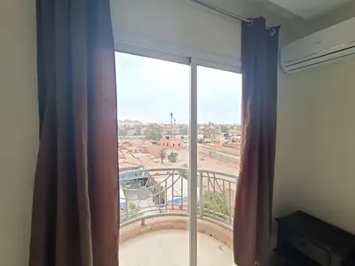 a large window with a view of a balcony at family apartment 31 in Marrakech