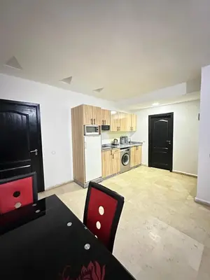a kitchen with a table and chairs in a room at family apartment 32 in Marrakech