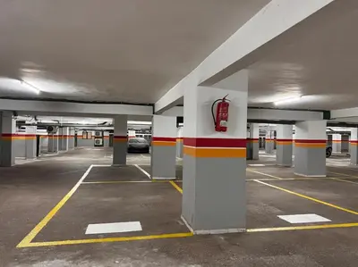 an empty parking lot with a car parked in it at Résidence Miramas 2 Cosy Appartment 2 in Marrakech