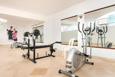 a gym with treadmills and exercise bikes in a room at Résidence Miramas 2 Cosy Appartment 2 in Marrakech