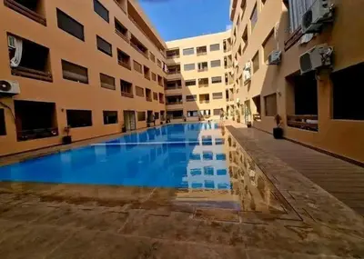 a swimming pool in the middle of a building at Appartement 2 chombr salon a marrakech in Marrakech