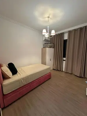 a bedroom with a bed and a chandelier at Appartement a gueliz Marrakech in Marrakech