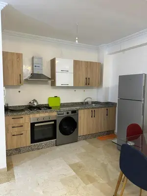 a kitchen with a stove and a dishwasher at Appartement a gueliz Marrakech in Marrakech