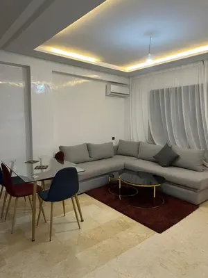 a living room with a couch and a table at Appartement a gueliz Marrakech in Marrakech