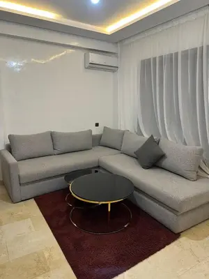 a living room with a couch and a table at Appartement a gueliz Marrakech in Marrakech