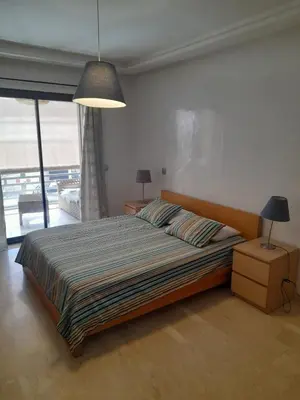 a bedroom with a large bed and a large window at Two Bedroom Luxury Appt with air conditioning parking and pool in Marrakech