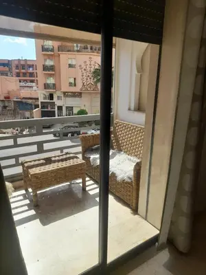 a view of a balcony with a table and chairs at Two Bedroom Luxury Appt with air conditioning parking and pool in Marrakech
