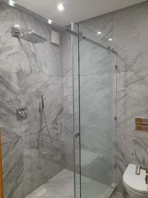 a shower with a glass door in a bathroom at Two Bedroom Luxury Appt with air conditioning parking and pool in Marrakech