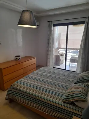 a bedroom with a bed and a window with a view at Two Bedroom Luxury Appt with air conditioning parking and pool in Marrakech