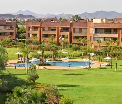 a resort with a pool in front of a building at Luxueux Appartement Prestigia Agate in Marrakech