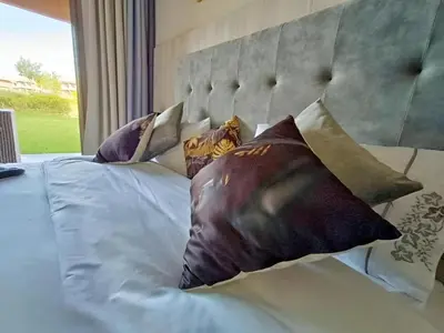 a bedroom with a bed with pillows on it at Luxueux Appartement Prestigia Agate in Marrakech